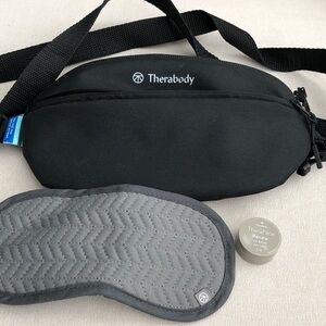 Therabody Black Travel Bag with sleep mask and lip balm